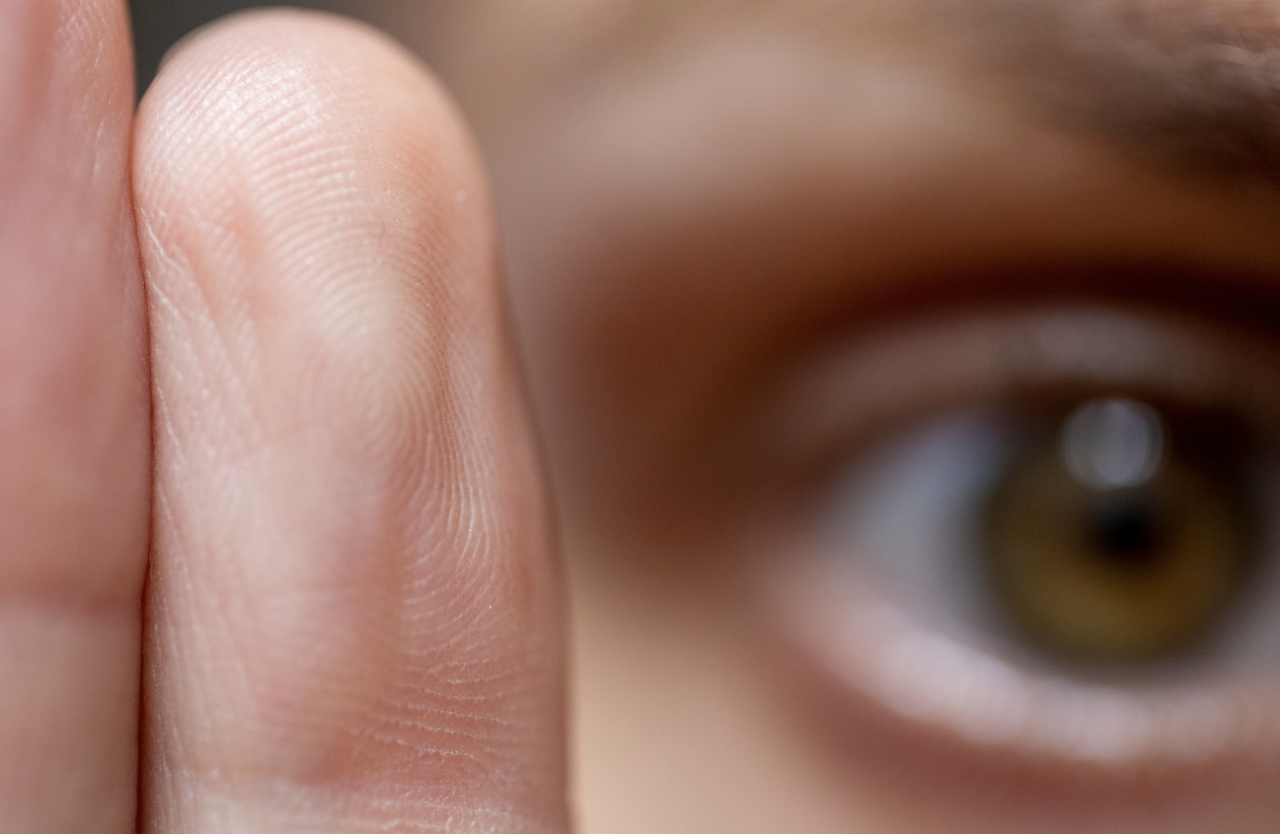 Close-up of an eye and fingers used in Eye Movement Desensitization and Reprocessing (EMDR) therapy session, demonstrating the mental health benefits of EMDR therapy.